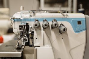 Detailed view of a modern sewing machine in a workshop.